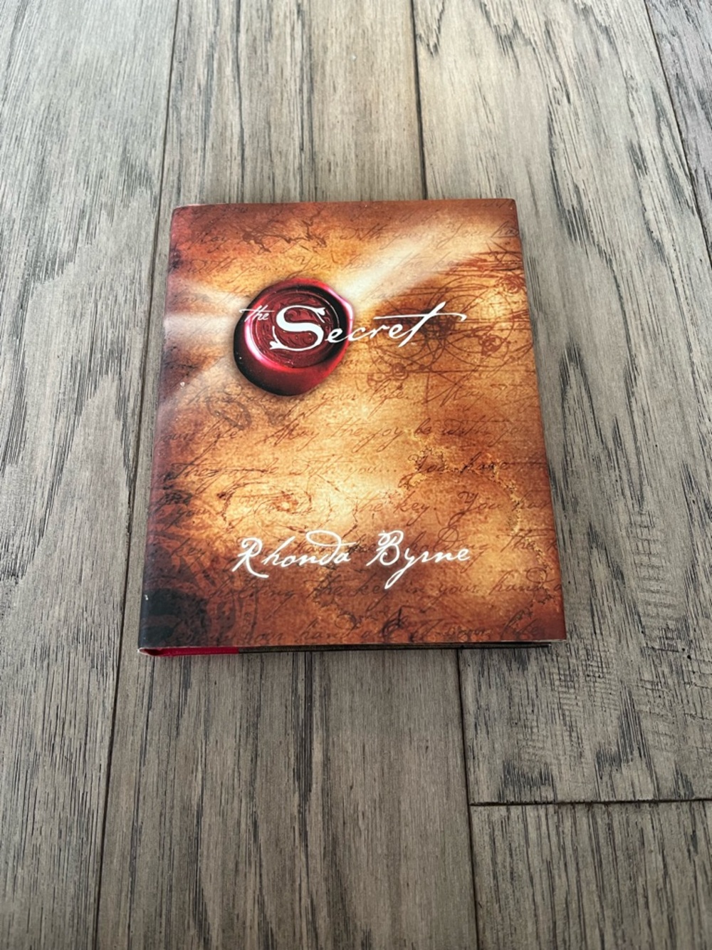 The Secret by Rhonda Byrne Hardcover Book - Brown & Red Cover
